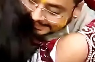 Cute Indian bride kissing undeceitful
